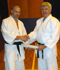 Richard (on left) receiving his 5th Dan Certificate