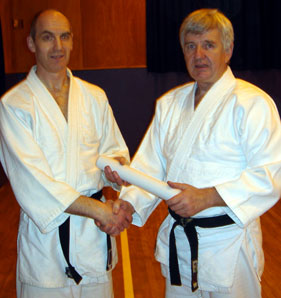Tom (on left) receiving his 5th Dan Certificate
